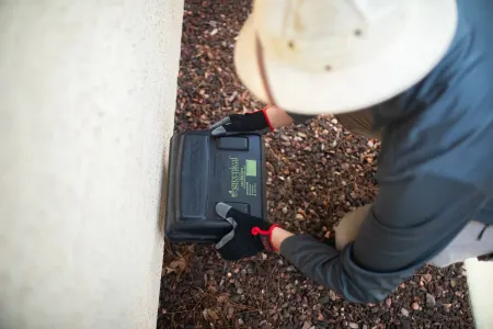 greenleaf exterminator placing rodent bait station